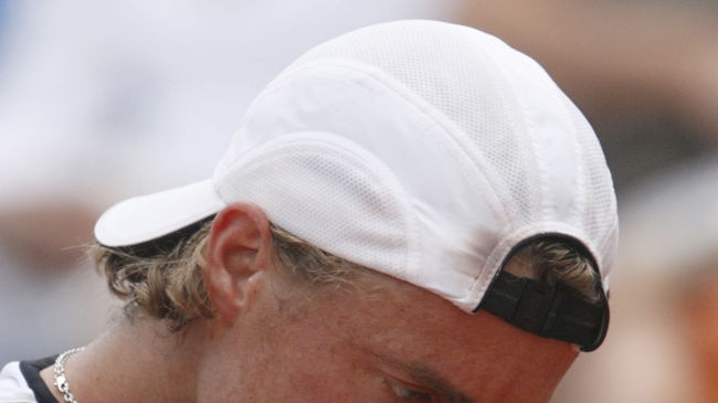 Lleyton Hewitt wipes brow during loss to Gael Monfils