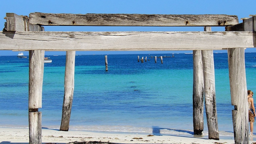 Aqua blue water with rickety wooden jetty