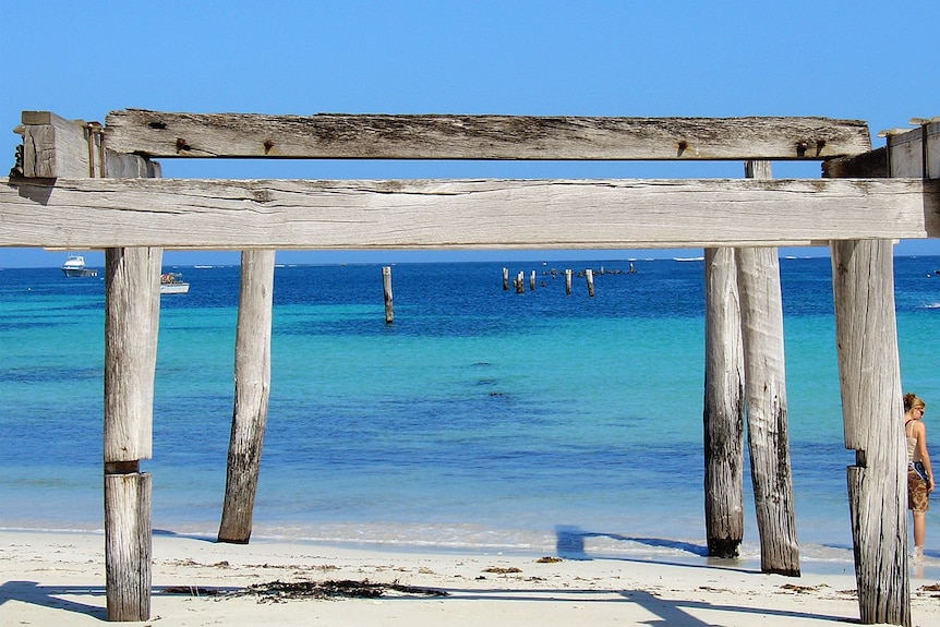 Aqua blue water with rickety wooden jetty