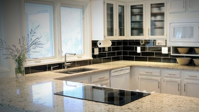 A shiny white and grey kitchen countertop.