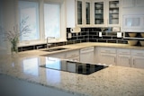 A shiny white and grey kitchen countertop.