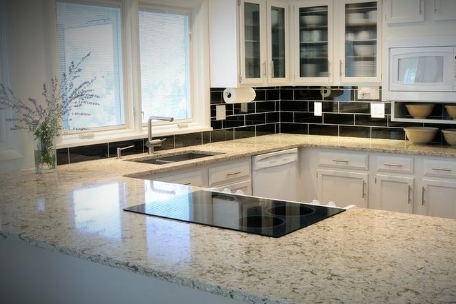 A shiny white and grey kitchen countertop.