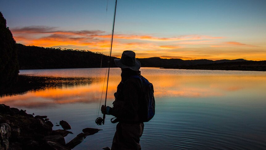A fisherman looks over Westons Lake in Tasmania's Central Highlands as the sun sets.