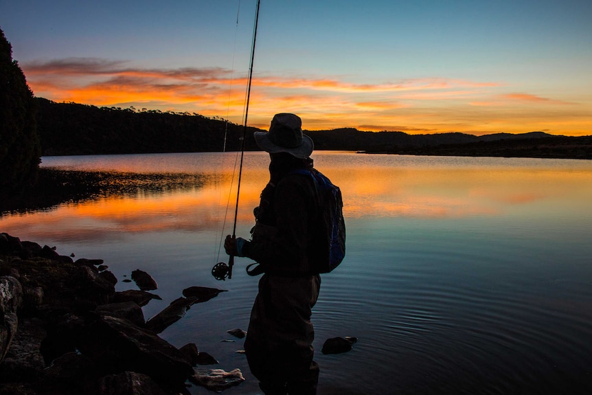 A fisherman looks over Westons Lake in Tasmania's Central Highlands as the sun sets.