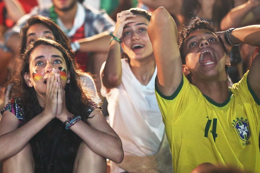 Fans at Copacabana Beach react during the Germany-Algeria match at the World Cup on June 30, 2014.