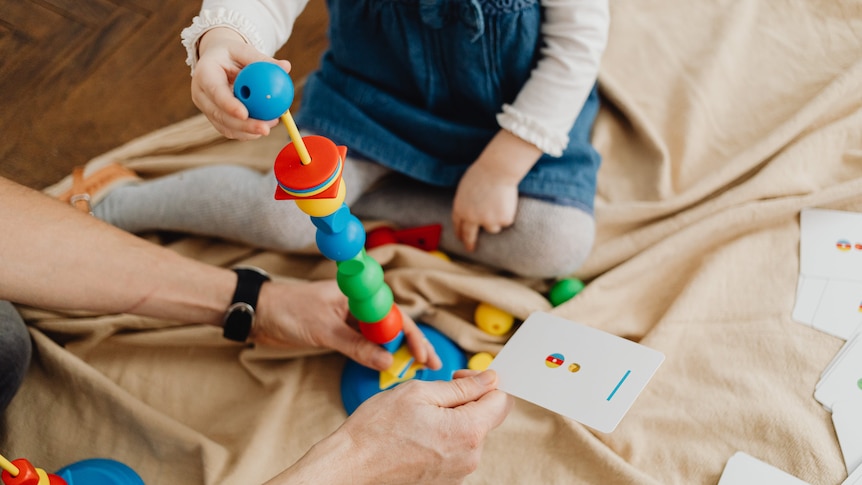 child playing with coloured blocks