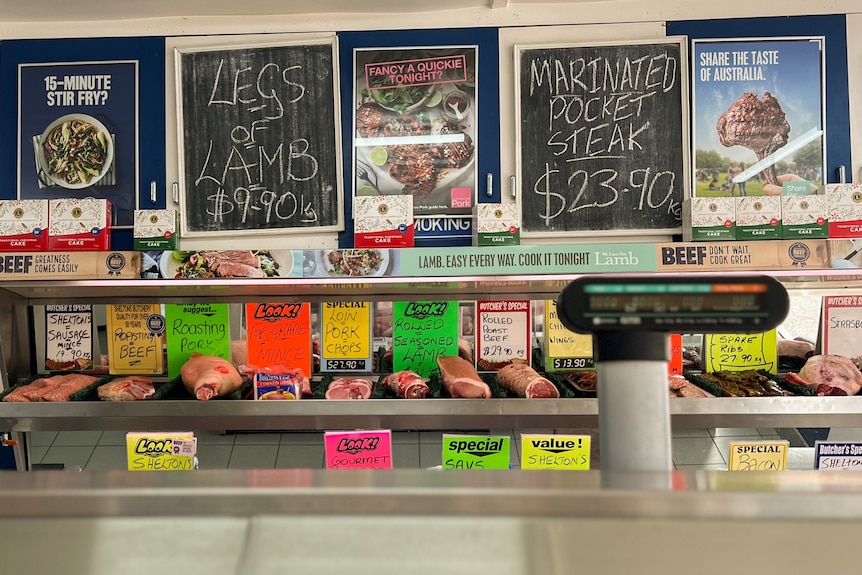 Blackboard signs and posters inside a butcher's shop