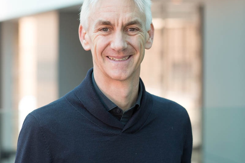 A portrait photo of Alexander Reilly who is smiling. 