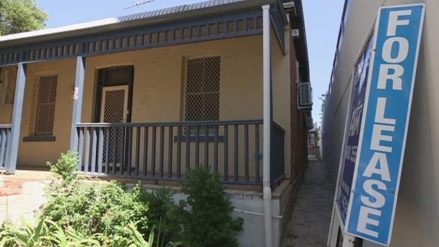 A house with a veranda and a for lease sign outside, leaning against wall