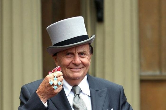 Dr Barry Humphries with his Most Excellent Commander of the British Empire