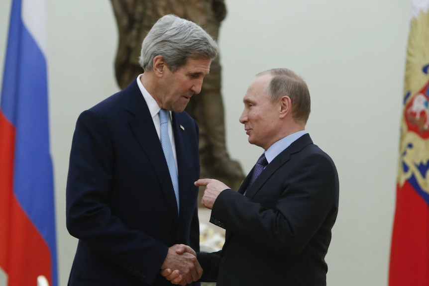 Russian President Vladimir Putin speaks with US Secretary of State John Kerry