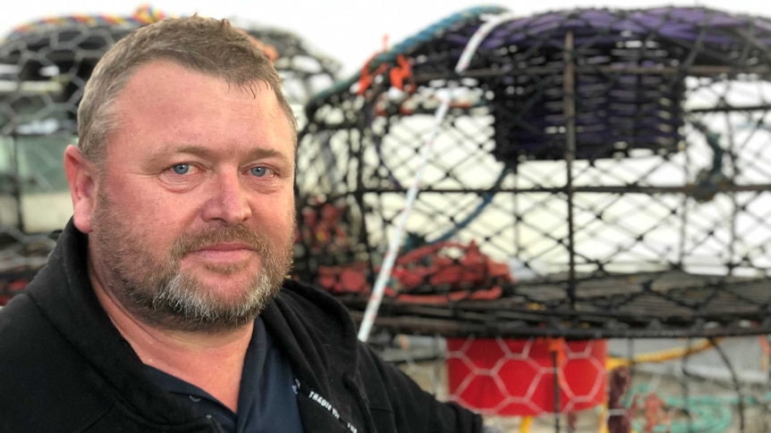 Crayfisherman Nicky Cawthorne leans on his ute next to the water in Port MacDonnell.