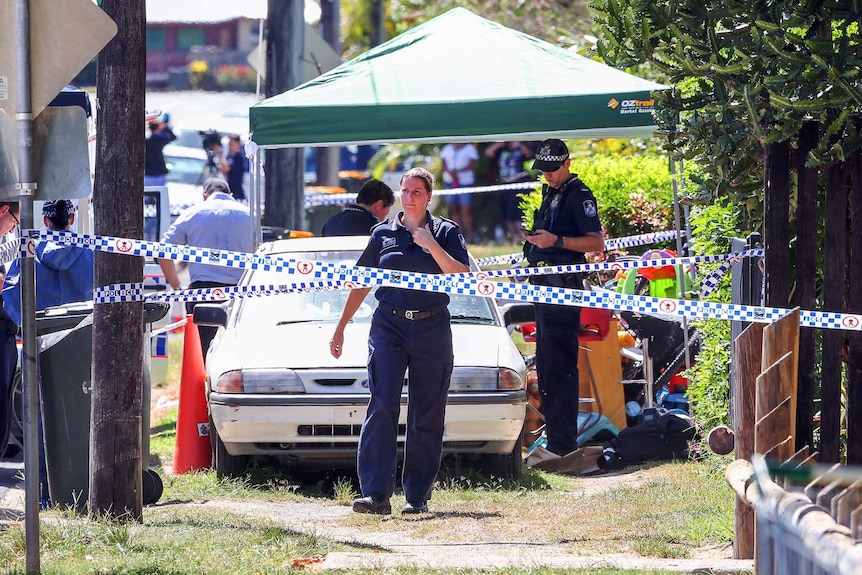Police attend a crime scene after eight children were found dead