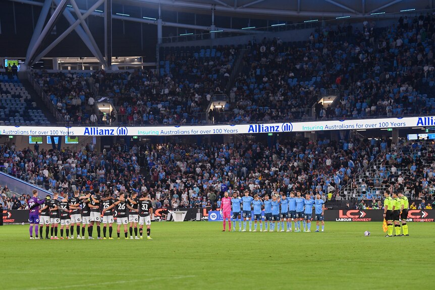 Players and fans standing for silence to remember victims of Bondi Junction attack