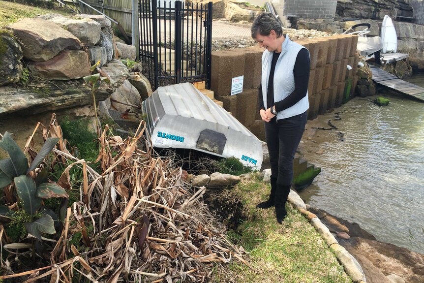 Sally Anne stands by sinkhole on her property.