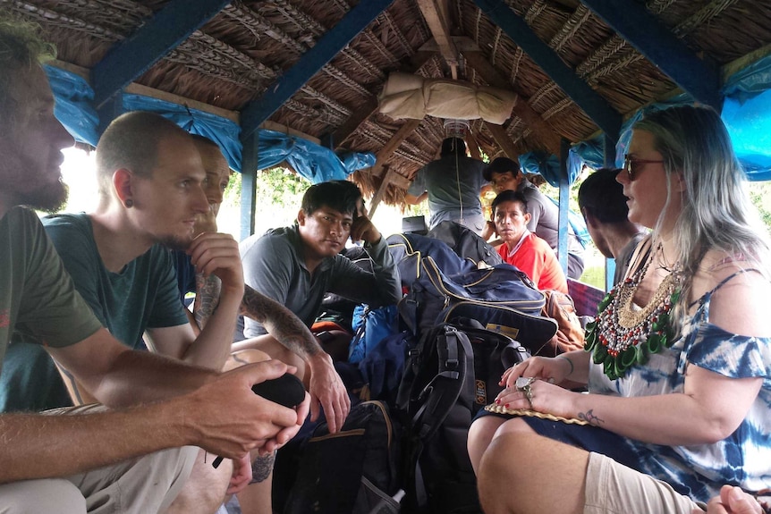 Meg on thatched boat with locals and tourists