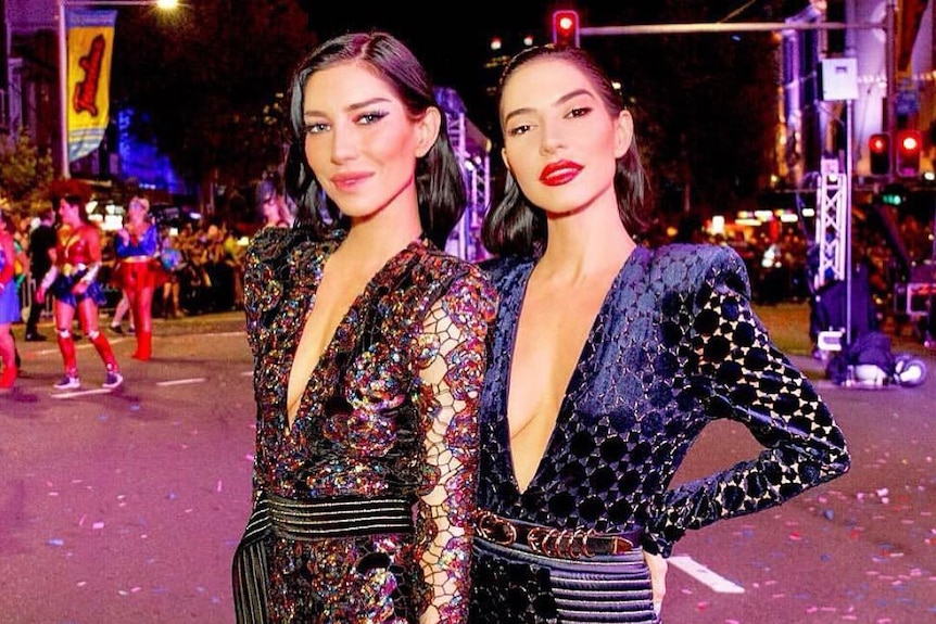 The Veronicas stand in the street at the Mardi Gras parade
