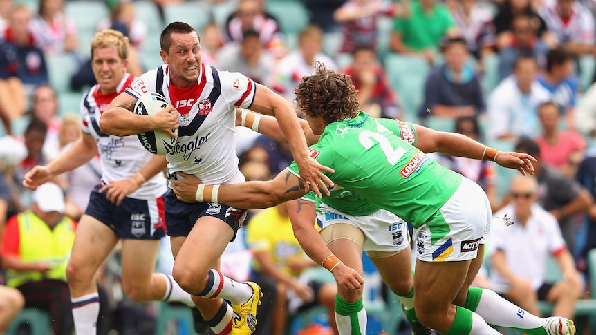 Roosters half-back Mitchell Pearce is tackled against Canberra in March 2012.