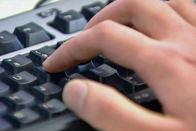 fingers typing on a keyboard close up