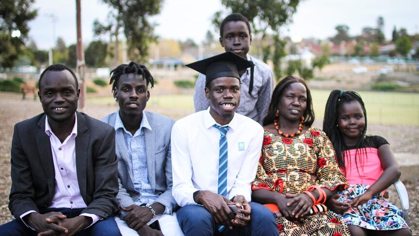 Pharmacy graduate Yong Deng is pictured with members of his family including his mother
