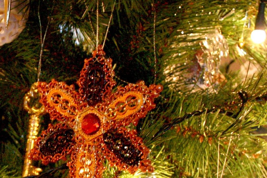 Decorations hang from a Christmas tree