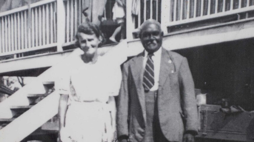 Black and white photo of a couple in front of their Queensland home