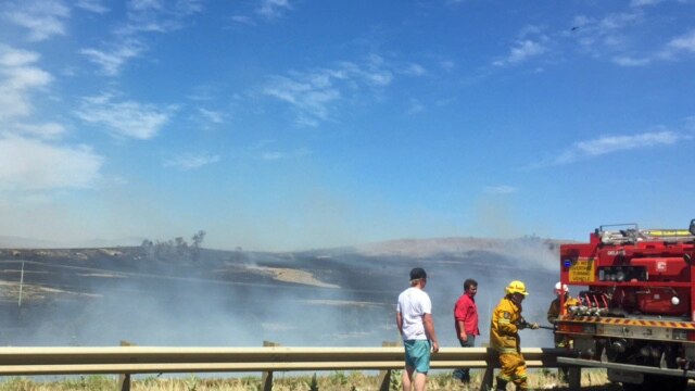 Firefighters on the side of the Midlands Highway south of Oatlands