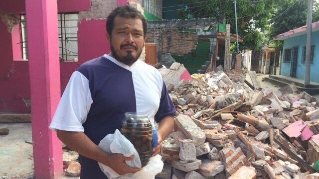 Victor Manuel stands in the wreckage of his house after the earthquake in Mexico.