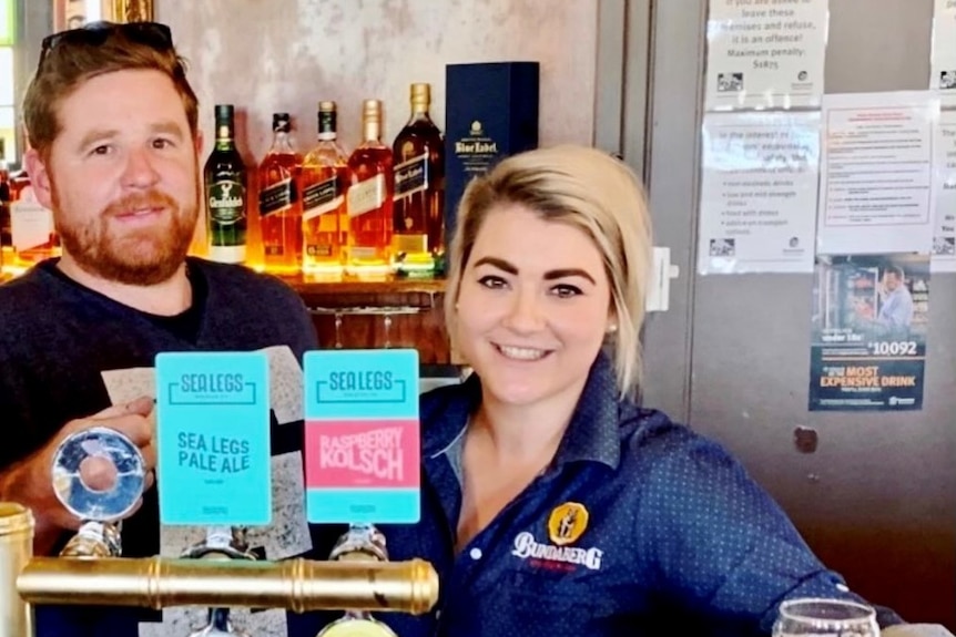 Man and woman behind the bar of a country pub