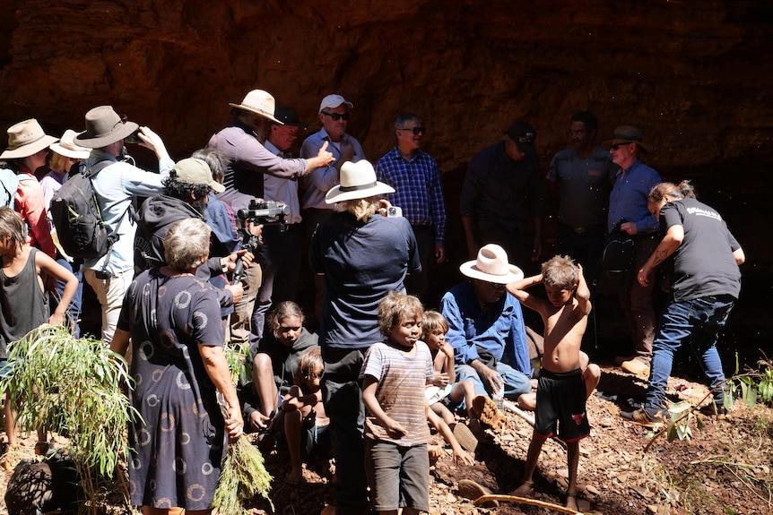 A large group of people gathered at an isolated spring.