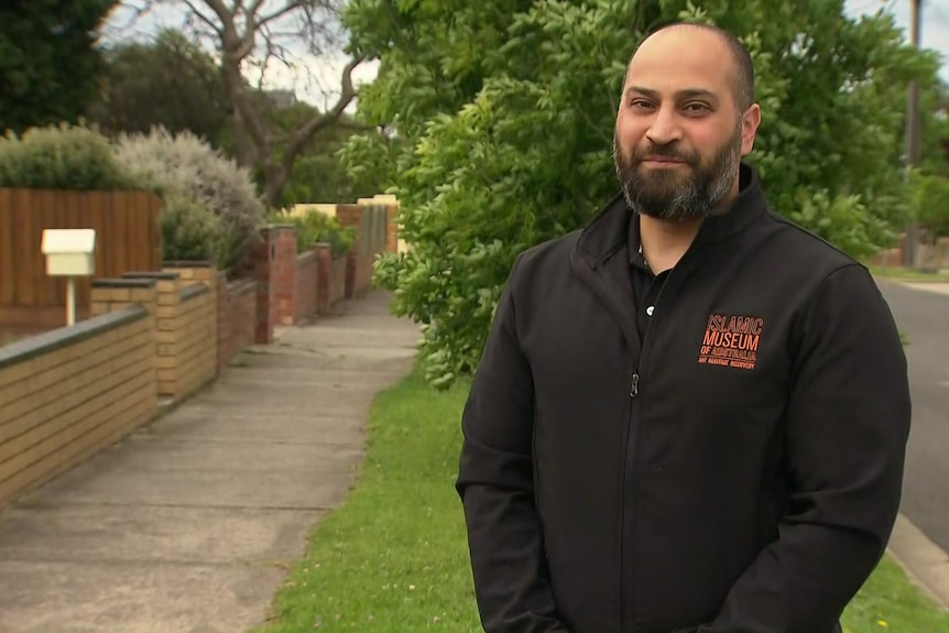 Moustafa Fahour stands on a nature strip in a suburban street.