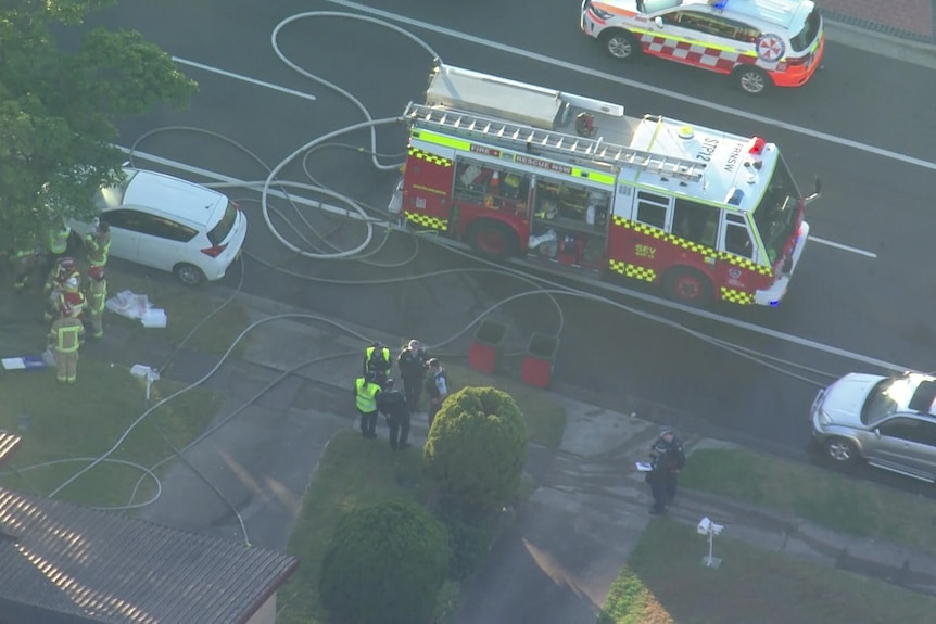 fire truck outside a house ravaged by fire in Wetherill Park, Sydney