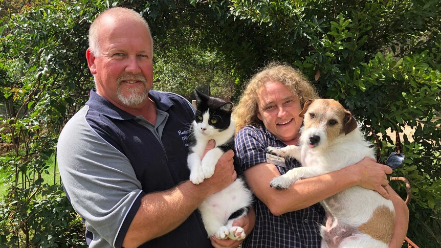 Susan and Jonathan Hopkins with their pets Neil and Alley at their property in Moruya.