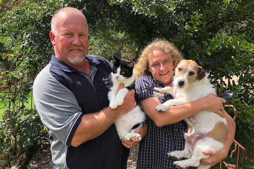 Susan and Jonathan Hopkins with their pets Neil and Alley at their property in Moruya.