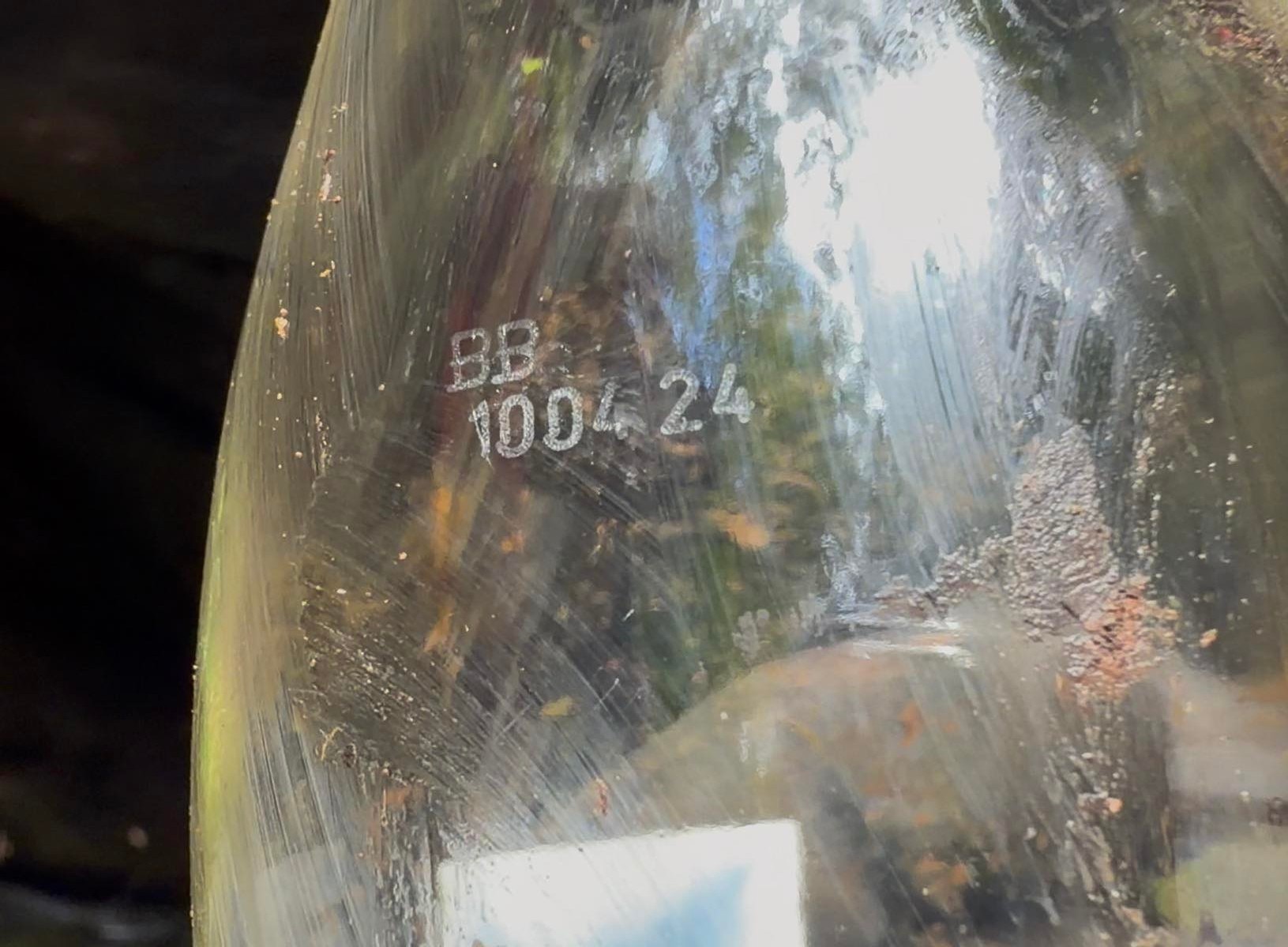 A best before label on a glass bottle.