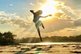 boy jumping on the beach during sunset