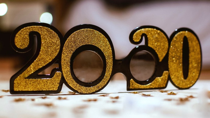 A pair of golden glasses shaped in 2020