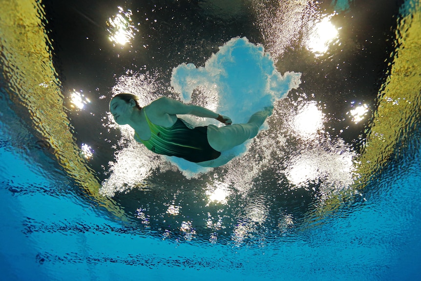 Brittany Broben enters the water during 10m platform diving semis