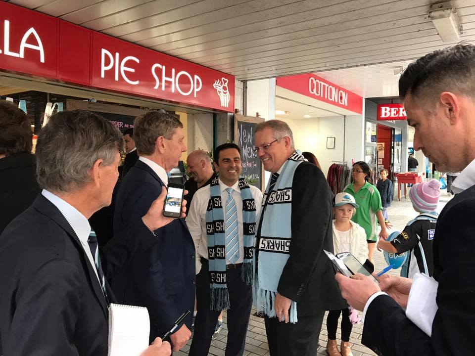 A group of men outside a pie shop