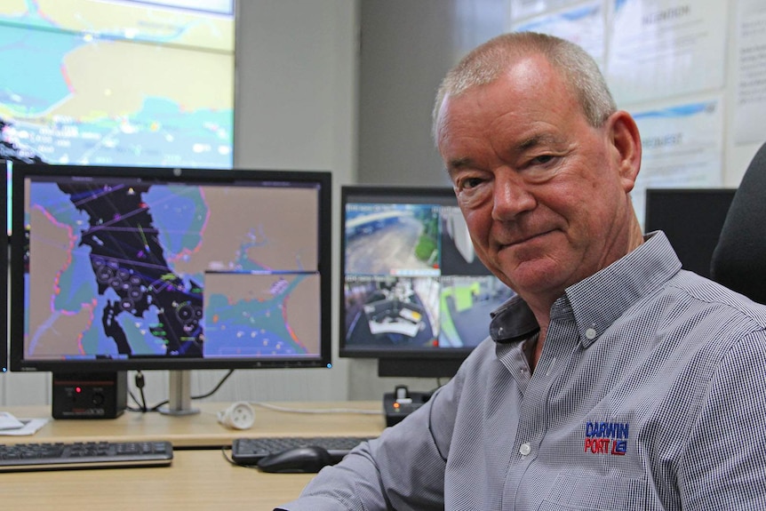 Ian Niblock sits in the port's harbour control room with several monitors behind him.