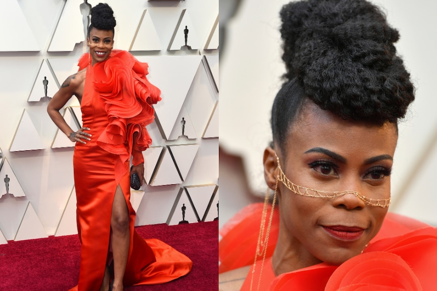 Hannah Beachler wears a bright orange dress and facial jewellery.