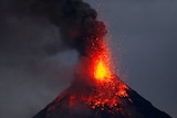 Red hot lava erupts from the top of the Mayon volcano