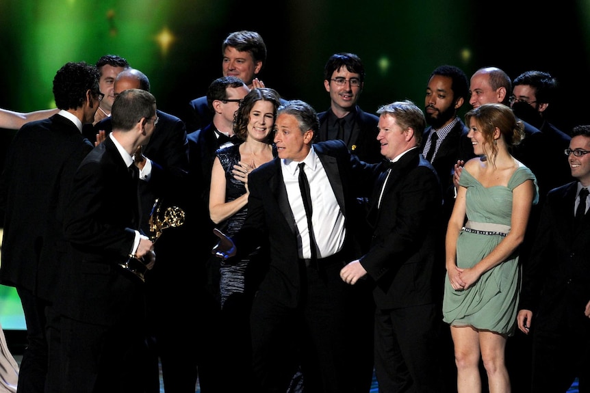 The cast of Daily Show With Jon Stewart accept their award at the Emmys