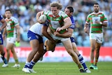 George Burgess is tackled by the Bulldogs.