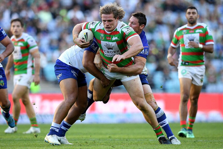 George Burgess is tackled by the Bulldogs.