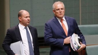 Josh Frydenberg and Scott Morrison stand in Parliament, holding folders.