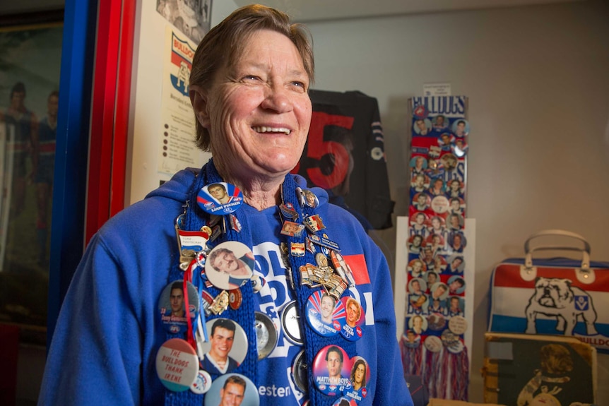 Irene Chatfield smiles cheerfully and dons her signature scarf of badges.