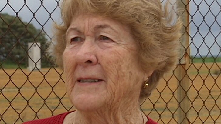 A fracking opponent, Peggy Hodgson, stands next to a wire fence in WA's Mid West