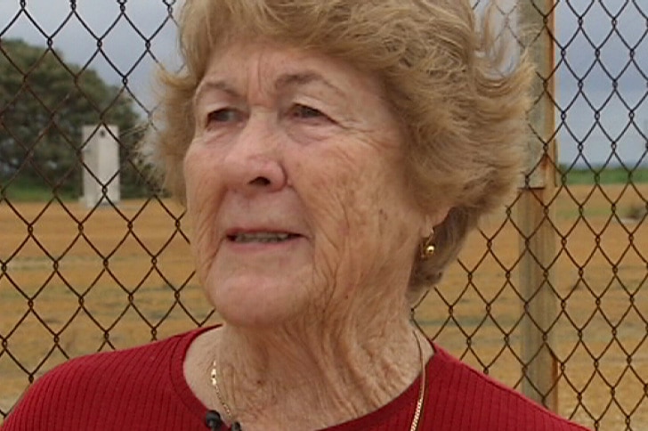 A fracking opponent, Peggy Hodgson, stands next to a wire fence in WA's Mid West