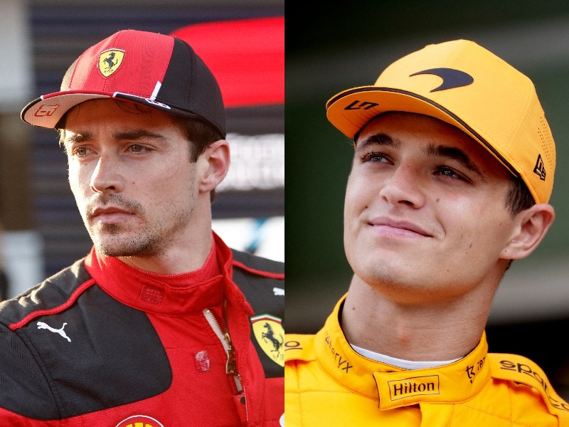 Two F1 drivers, one in red and the other in orange, in the paddock after a session